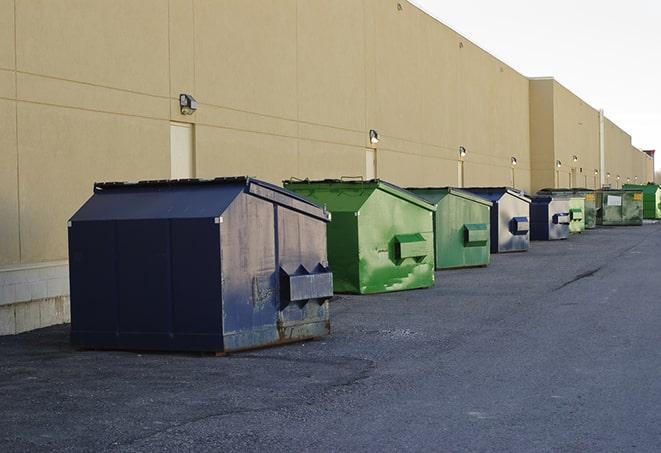 metallic dumpster units staged for construction garbage in Bradford